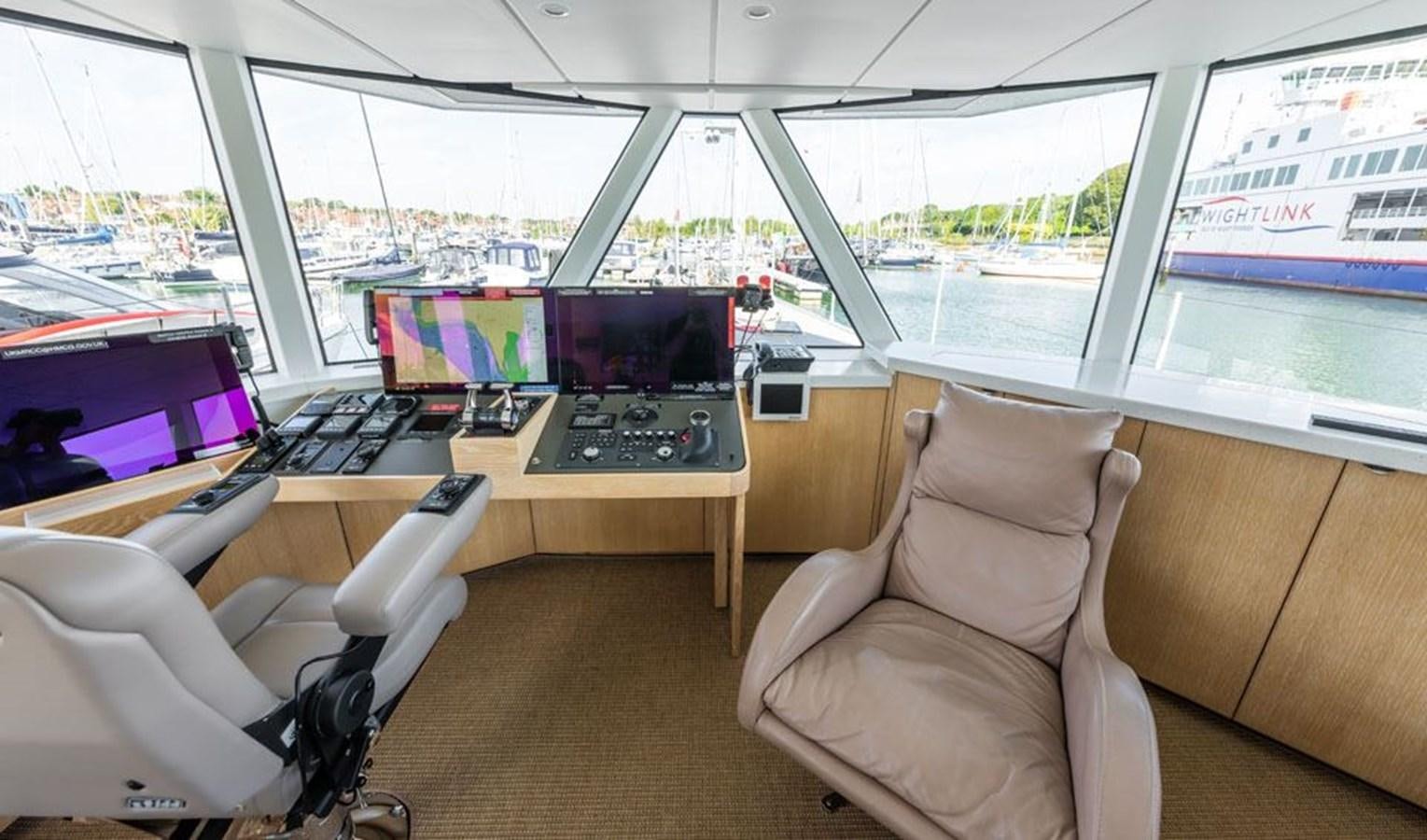 a room with a desk and chairs aboard GREY WOLF Yacht for Sale