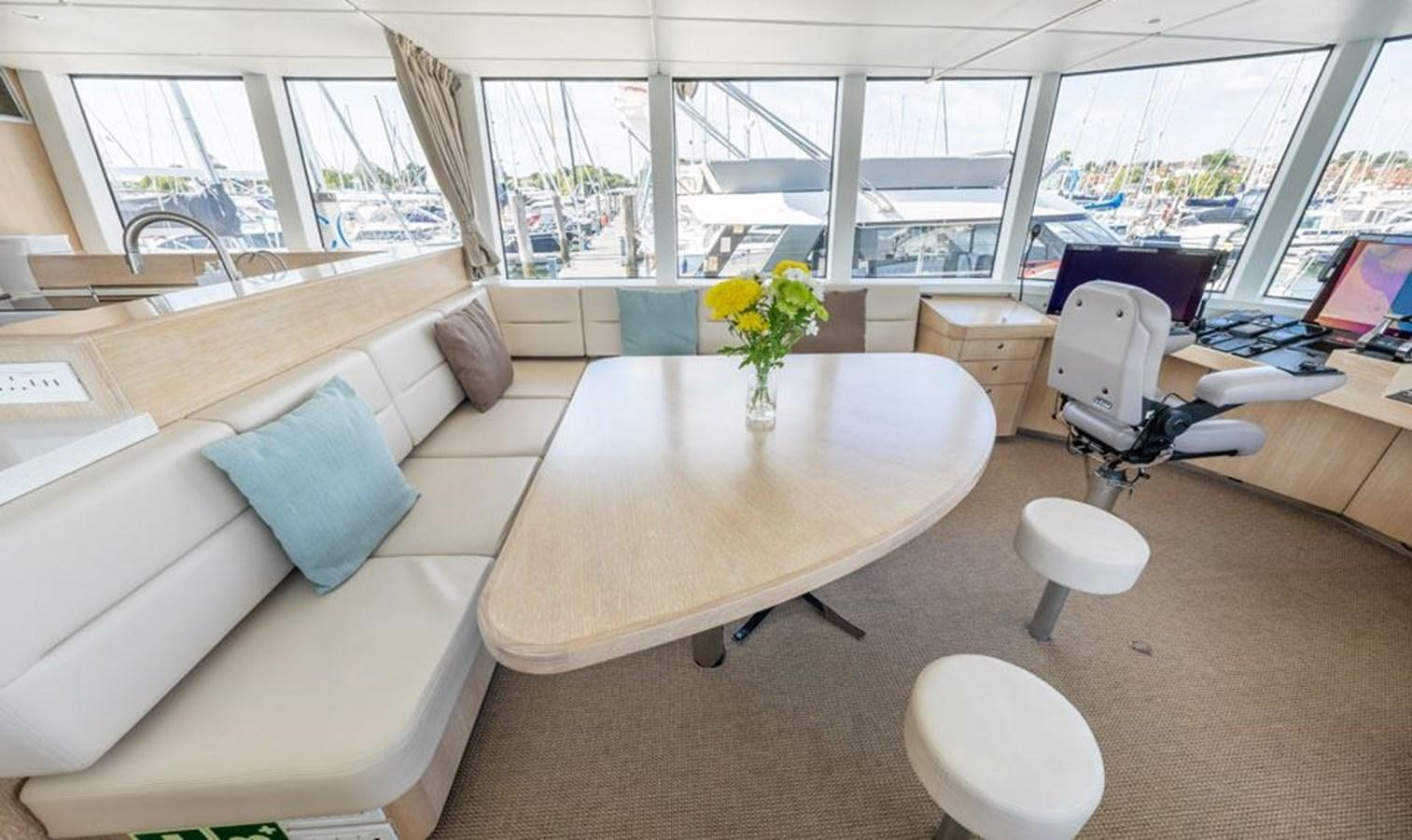 a room with a table chairs and a couch aboard GREY WOLF Yacht for Sale