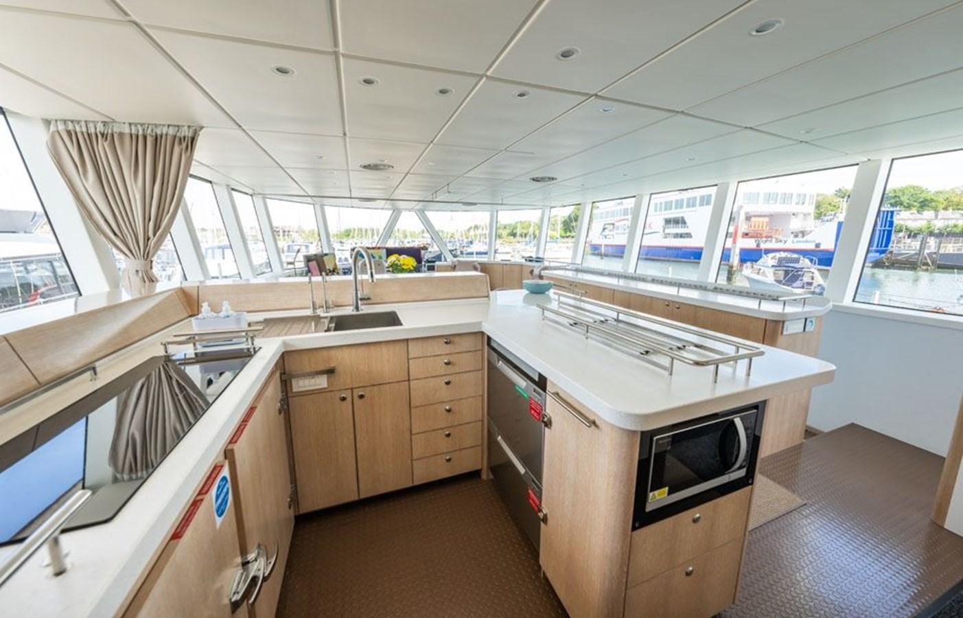 a kitchen with a large window aboard GREY WOLF Yacht for Sale