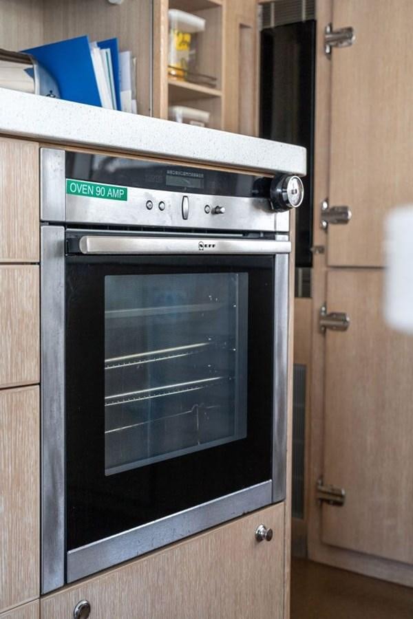 a kitchen with a black stove aboard GREY WOLF Yacht for Sale