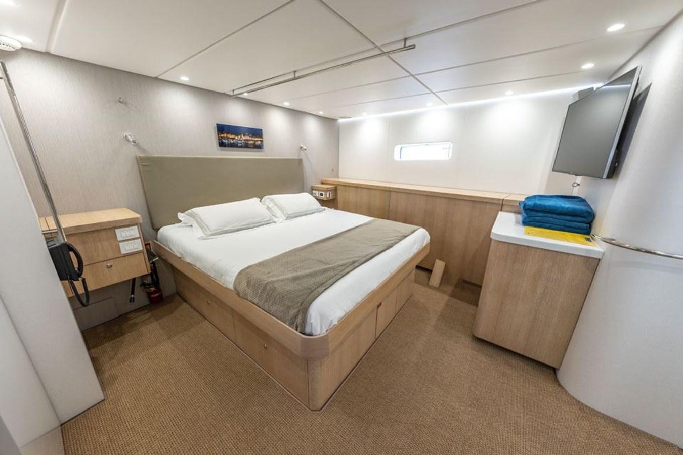 a room with a bed and a desk aboard GREY WOLF Yacht for Sale