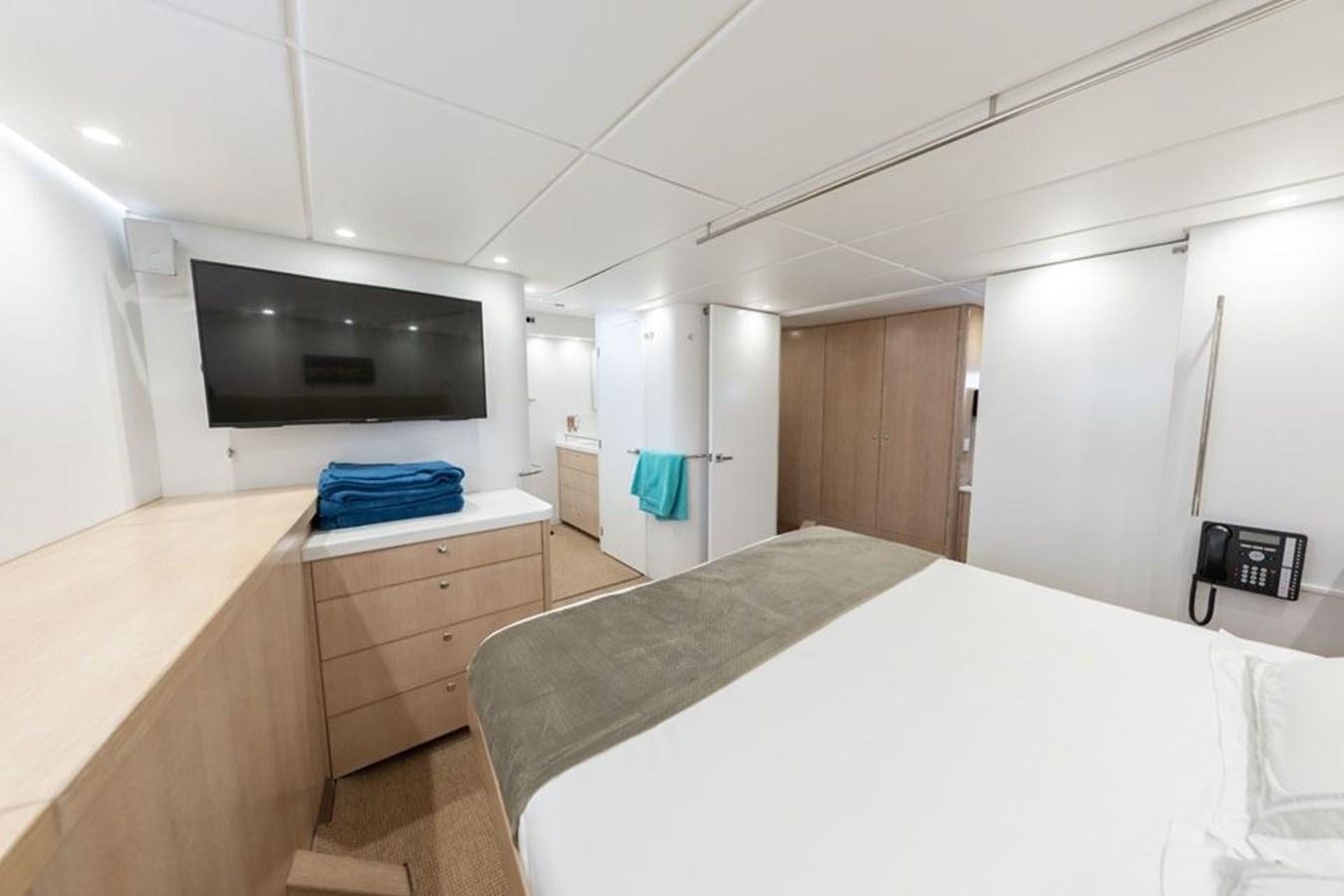 a room with a bed and a television aboard GREY WOLF Yacht for Sale