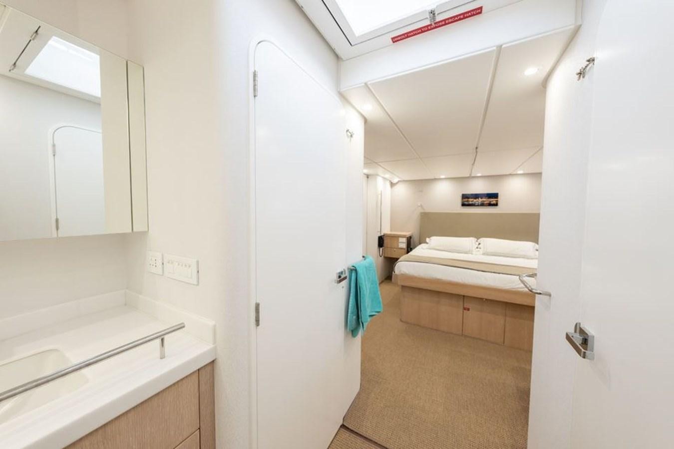 a room with a bed and a desk aboard GREY WOLF Yacht for Sale