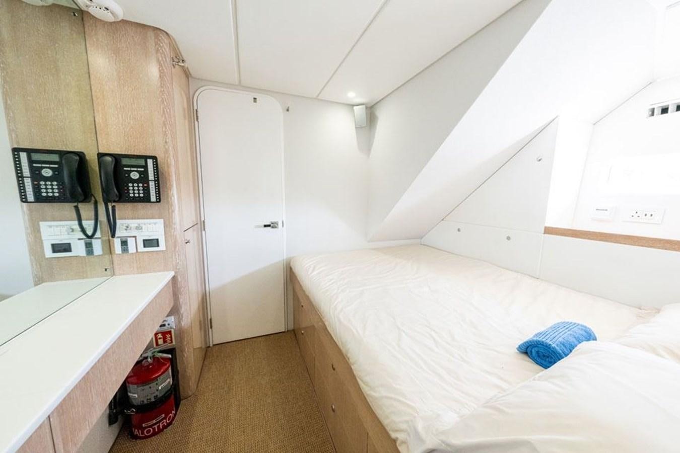 a small room with a bed and a small table aboard GREY WOLF Yacht for Sale