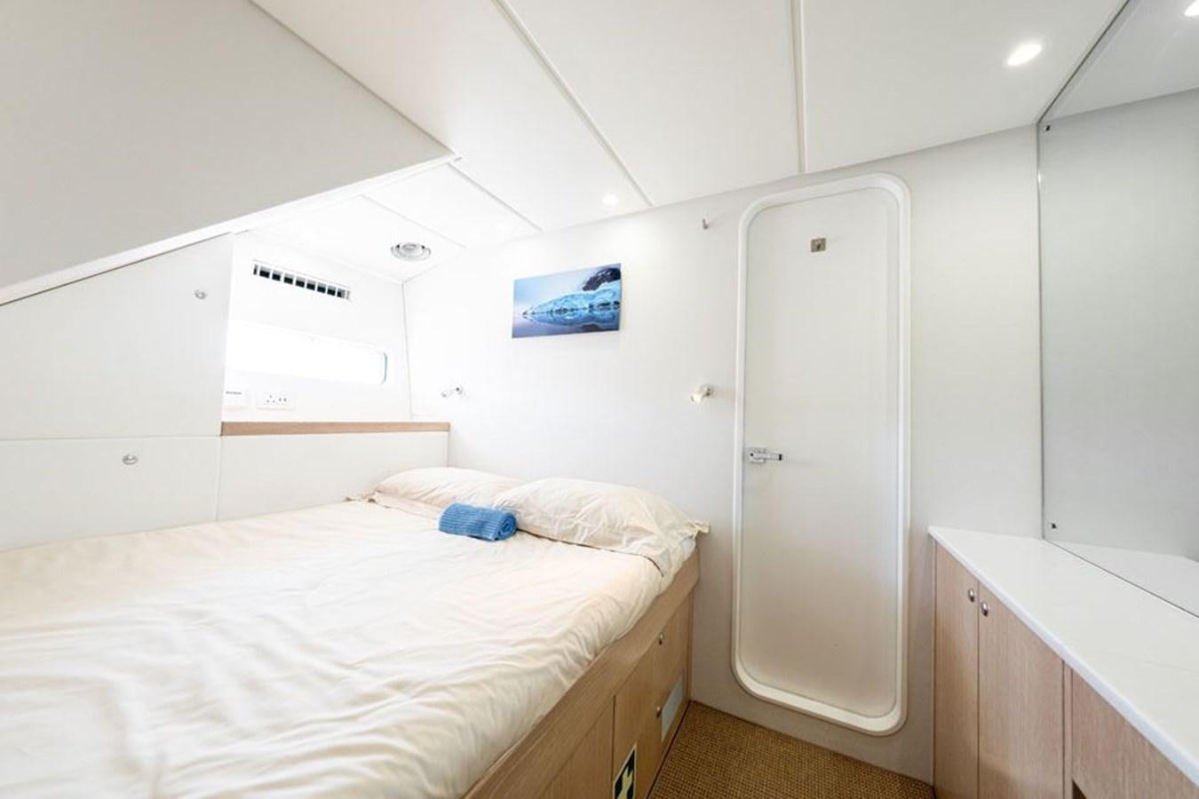 a room with a bed and a closet aboard GREY WOLF Yacht for Sale