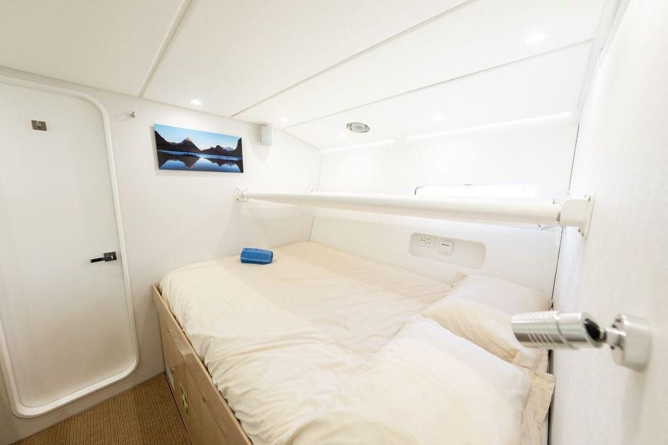 a room with a bed and a door aboard GREY WOLF Yacht for Sale