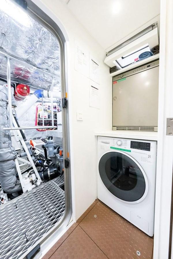 a laundry room with a washing machine aboard GREY WOLF Yacht for Sale