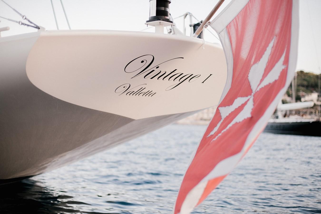 a sailboat with a red and white sail aboard VINTAGE I Yacht for Sale