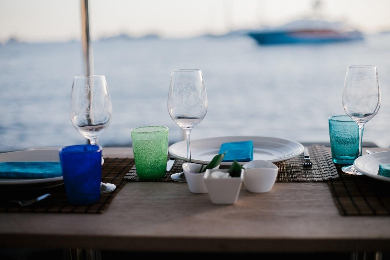 a table with glasses and plates aboard VINTAGE I Yacht for Sale