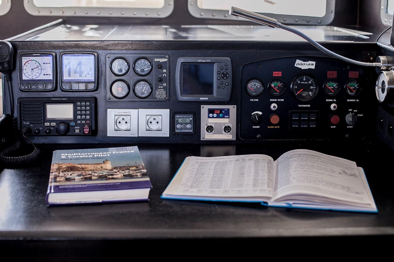 a book on a desk aboard VINTAGE I Yacht for Sale