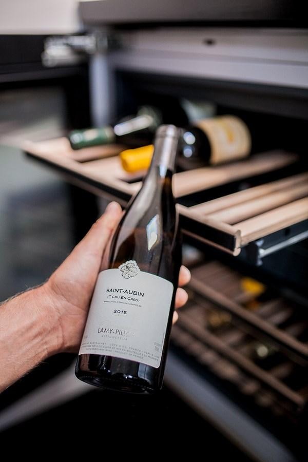 a hand holding a bottle of perfume aboard VINTAGE I Yacht for Sale