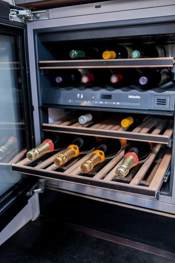 a shelf with bottles and cans aboard VINTAGE I Yacht for Sale