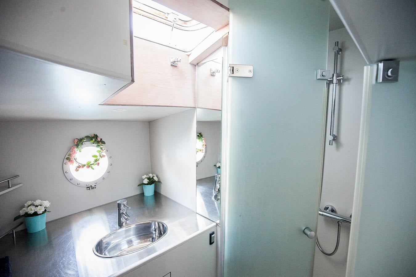 a kitchen with a sink and a refrigerator aboard VINTAGE I Yacht for Sale