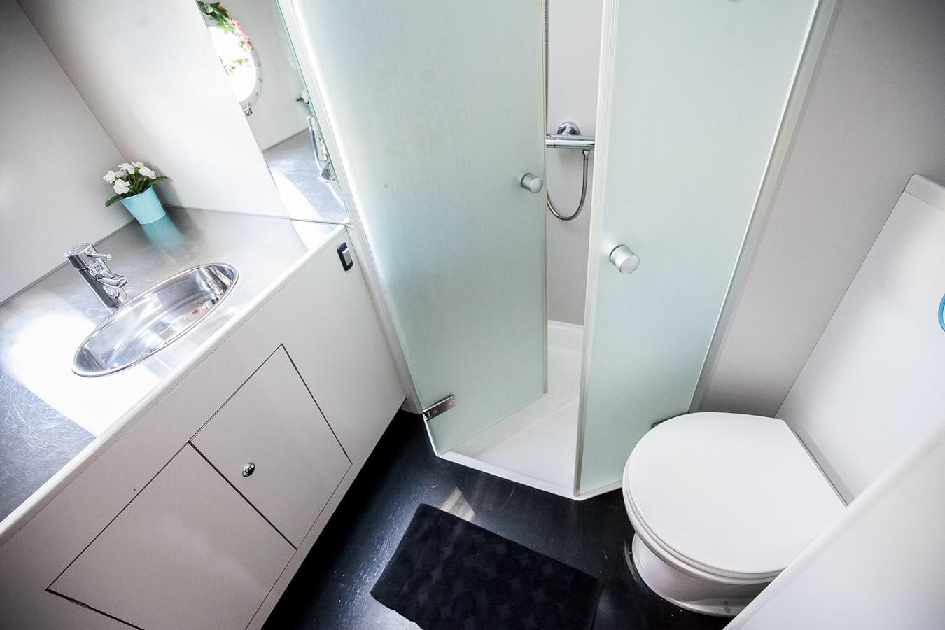 a bathroom with a sink toilet and a bathtub aboard VINTAGE I Yacht for Sale
