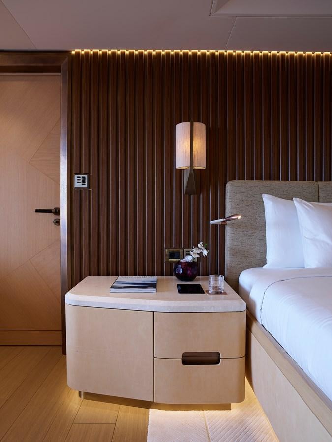 a room with a bed and a desk aboard COME TOGETHER Yacht for Charter