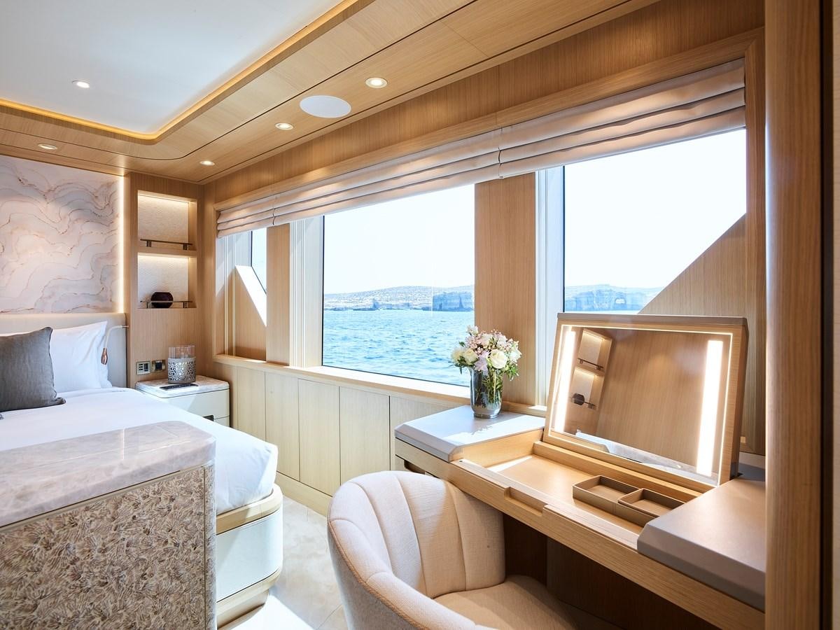 a room with a bed and a television aboard COME TOGETHER Yacht for Charter