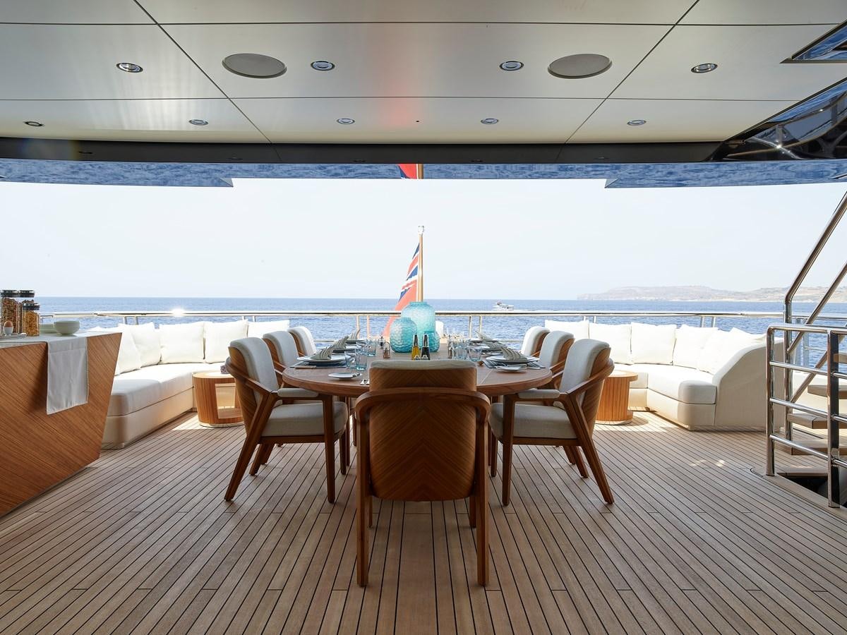 a table and chairs on a deck aboard COME TOGETHER Yacht for Charter
