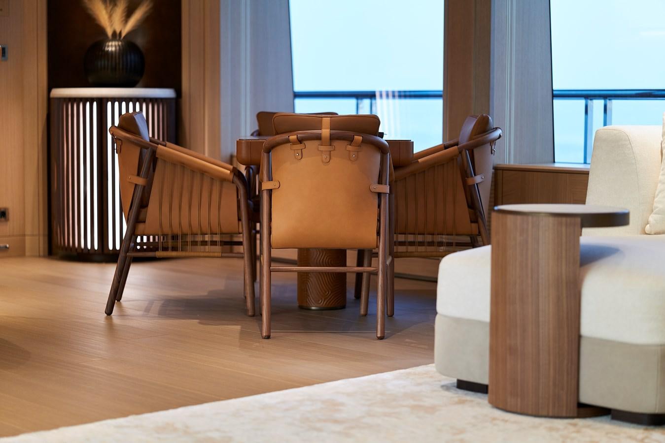 a wooden chair next to a table aboard COME TOGETHER Yacht for Charter