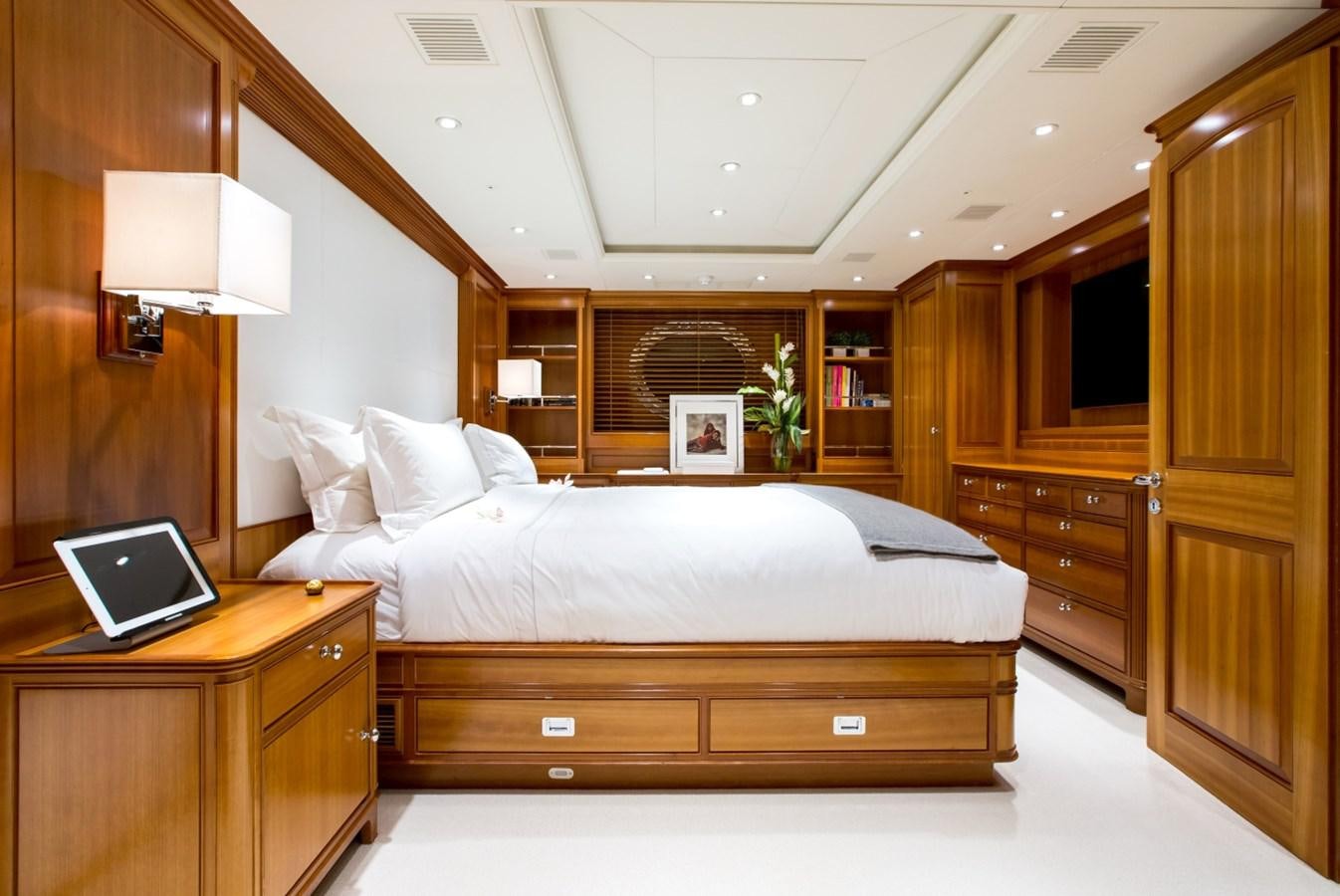 a bedroom with a laptop on the bed aboard PERSEUS Yacht for Charter