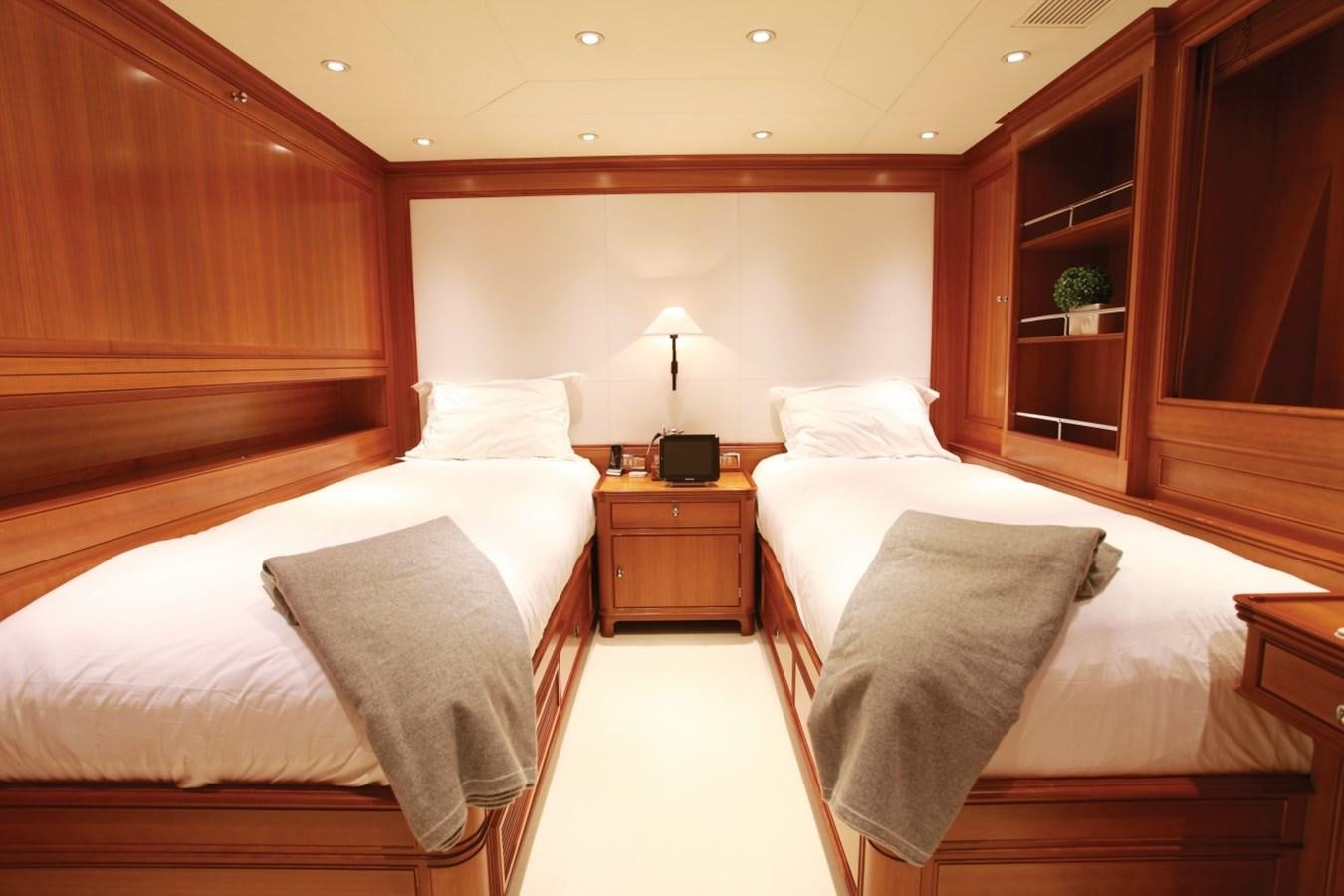 a room with a bed and a desk aboard PERSEUS Yacht for Charter
