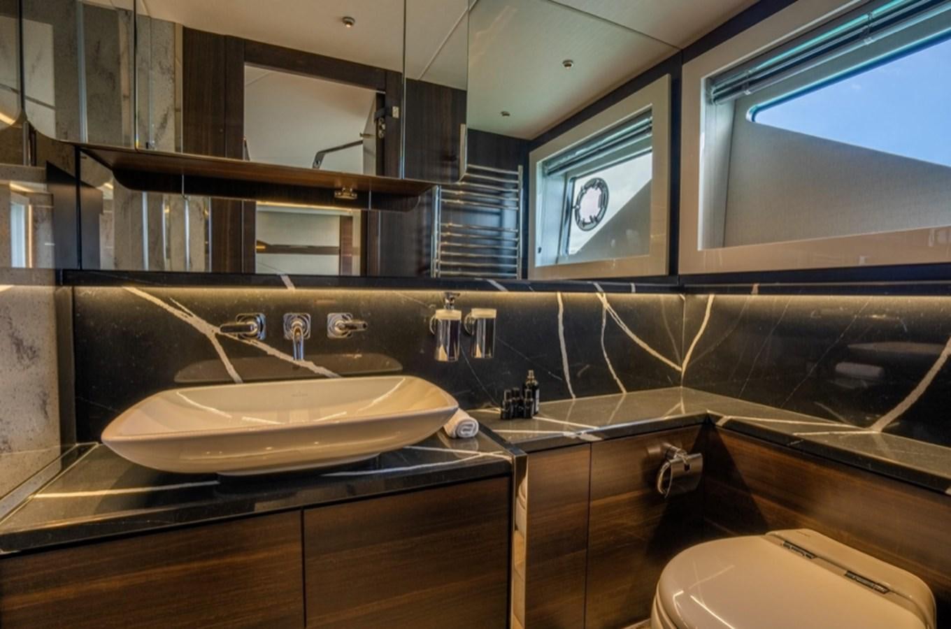 a bathroom with a sink and a mirror aboard FORZA Yacht for Sale