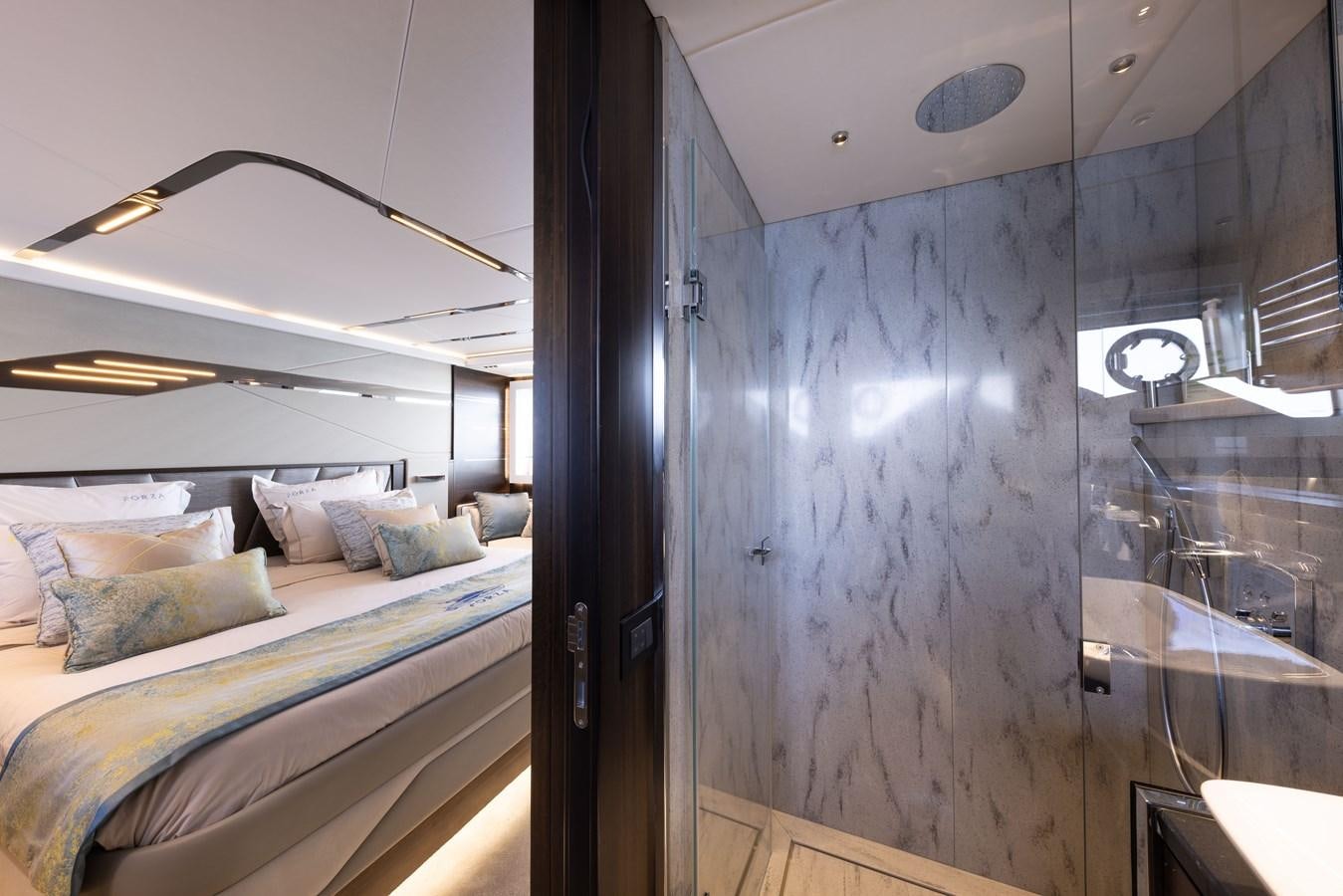 a bedroom with a bed and a mirror aboard FORZA Yacht for Sale