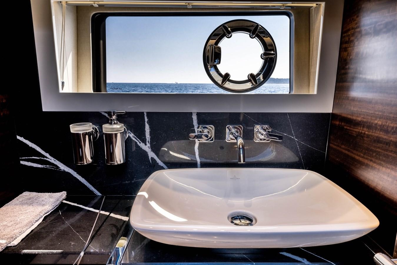 a sink with a mirror above it aboard FORZA Yacht for Sale