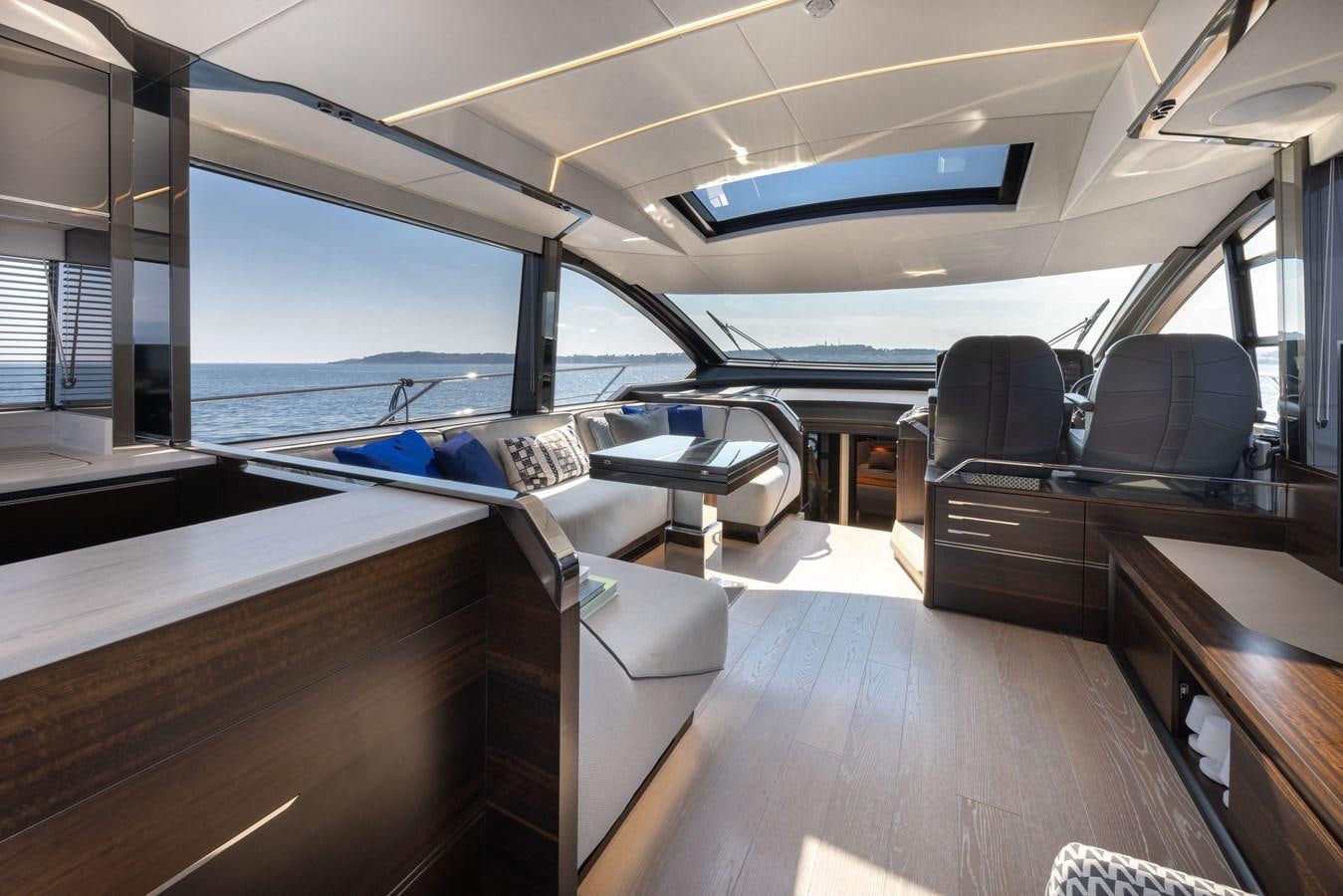 inside of a vehicle with a view of the water and the deck aboard FORZA Yacht for Sale