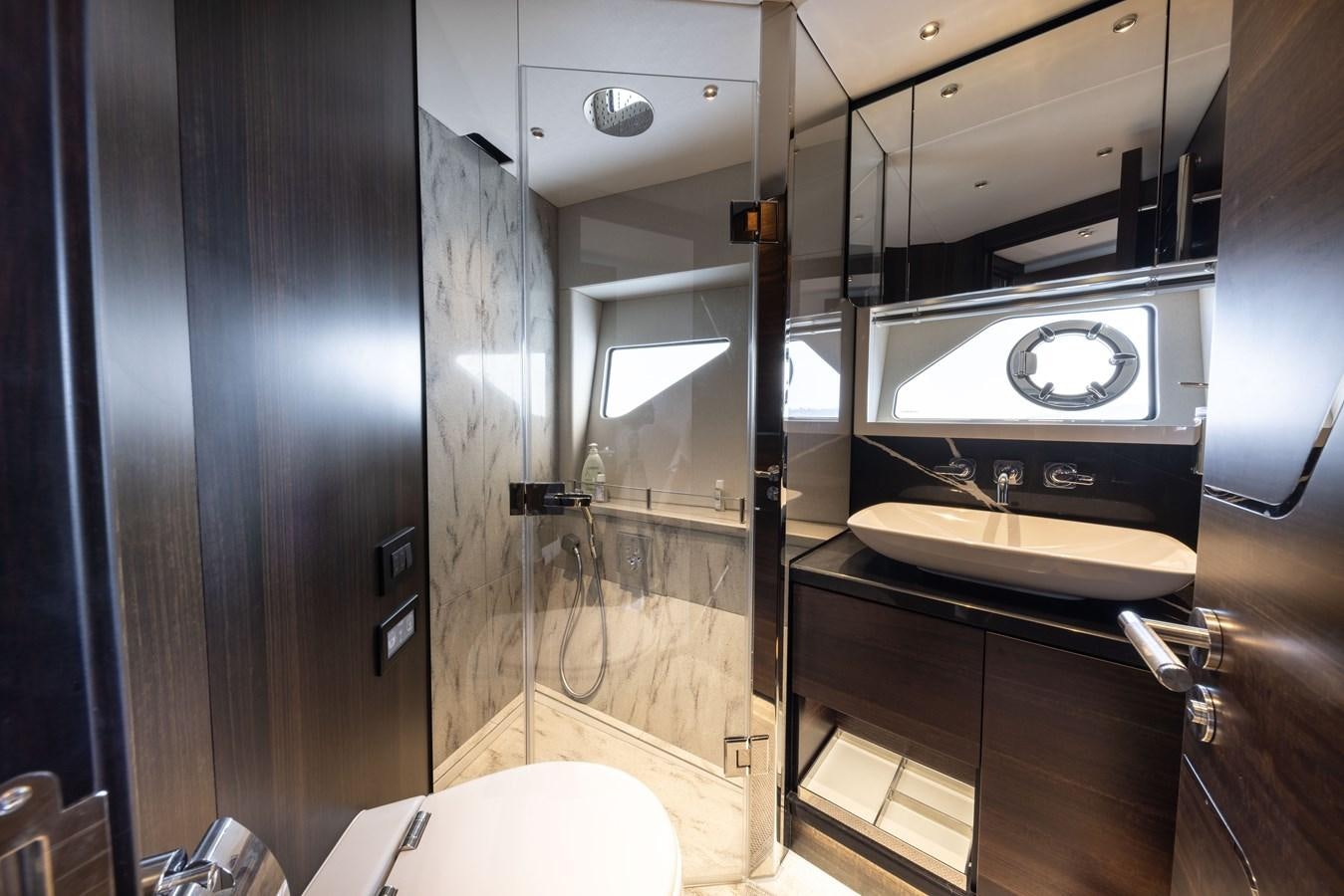 a bathroom with a sink and a mirror aboard FORZA Yacht for Sale