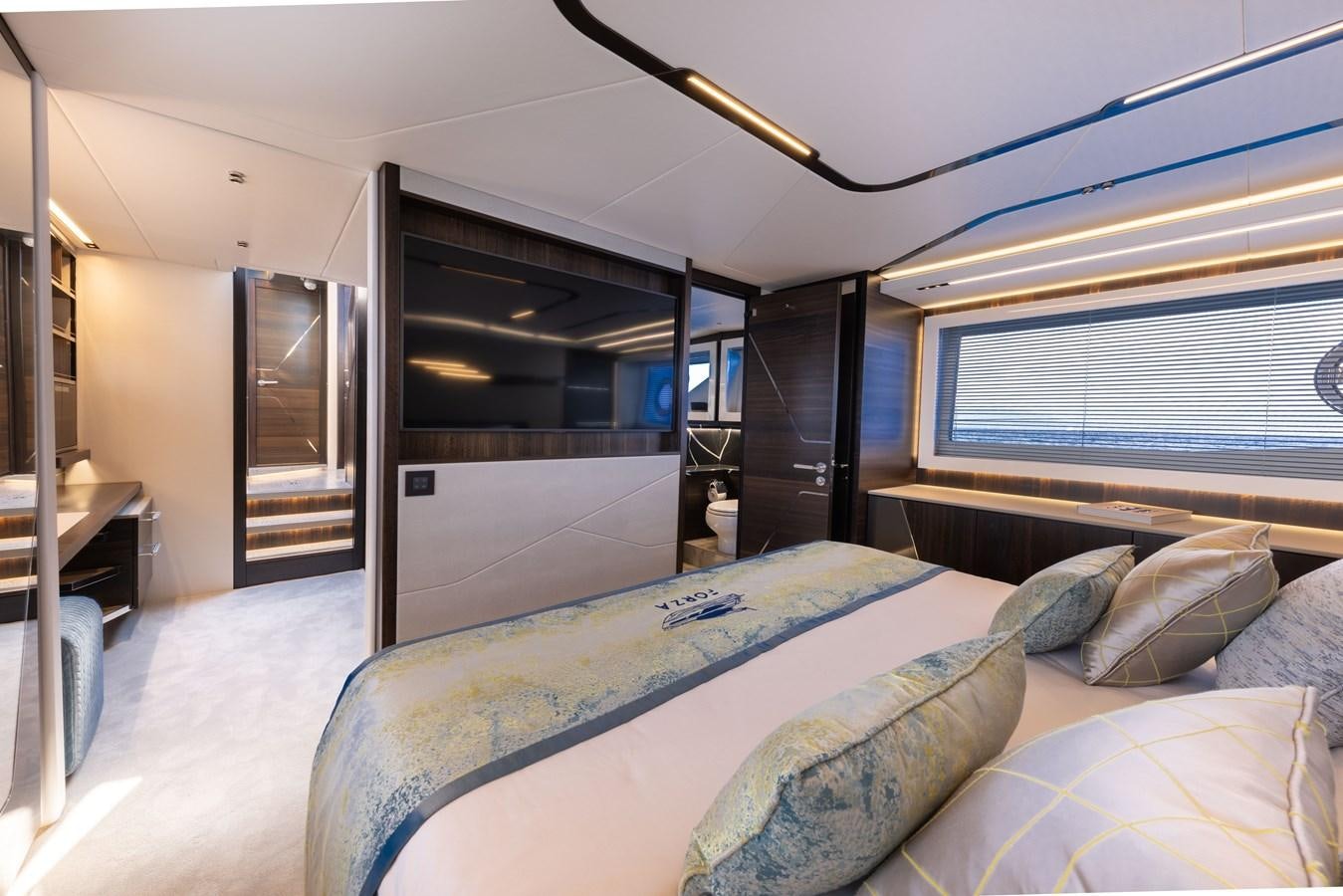 a bedroom with a bed and a large window aboard FORZA Yacht for Sale