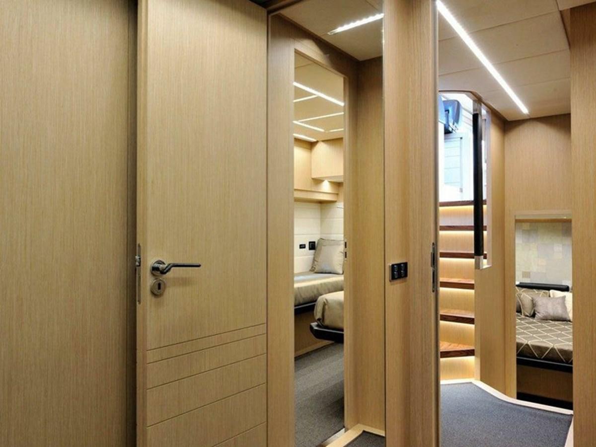 a bathroom with a wood door aboard AUSTIN PARKER - 72 FLY Yacht for Sale