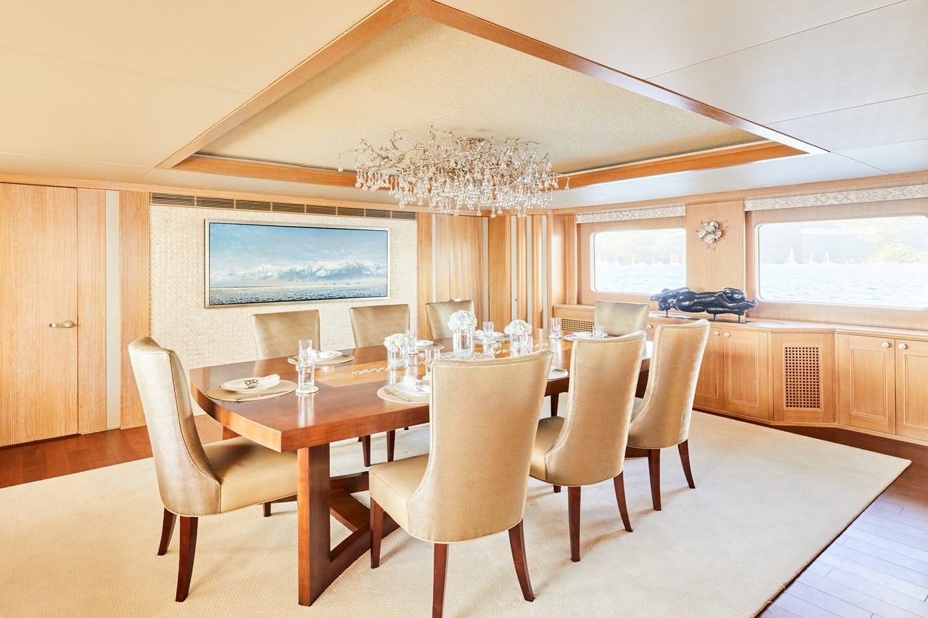 a dining room with a table and chairs aboard AMARA Yacht for Sale