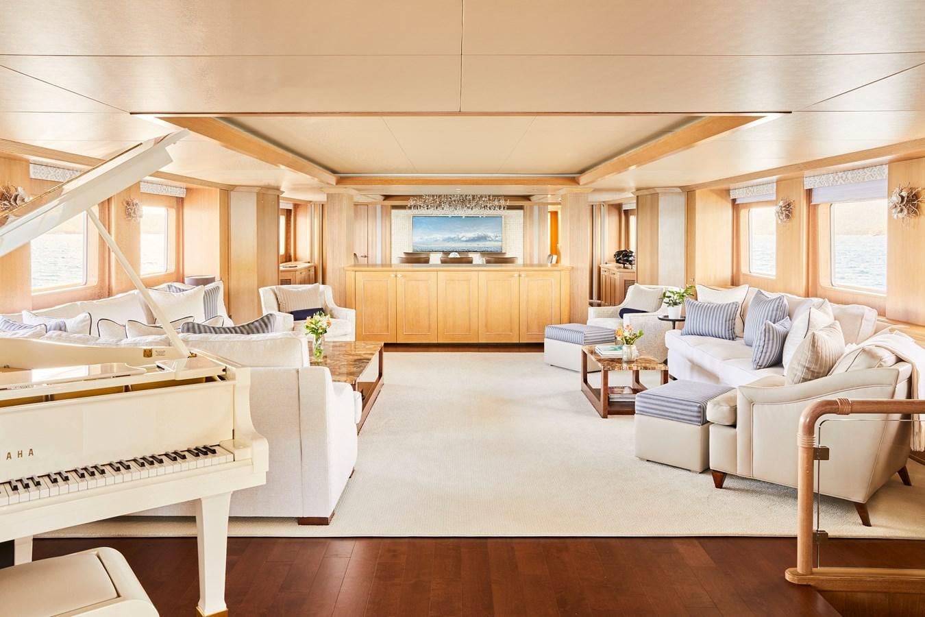 a large living room with white furniture aboard AMARA Yacht for Sale