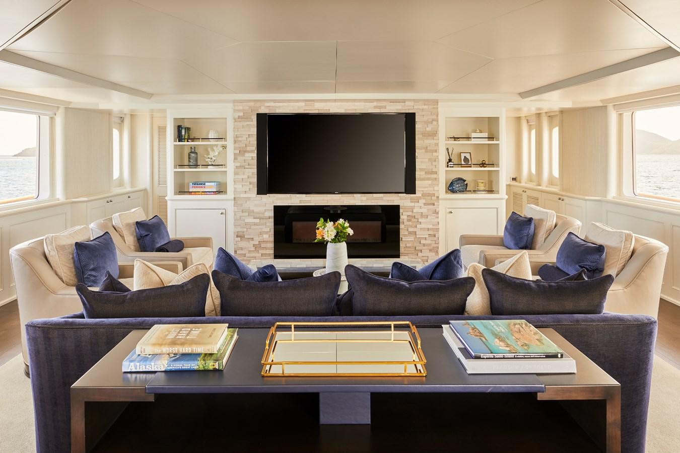a living room with a large tv aboard AMARA Yacht for Sale