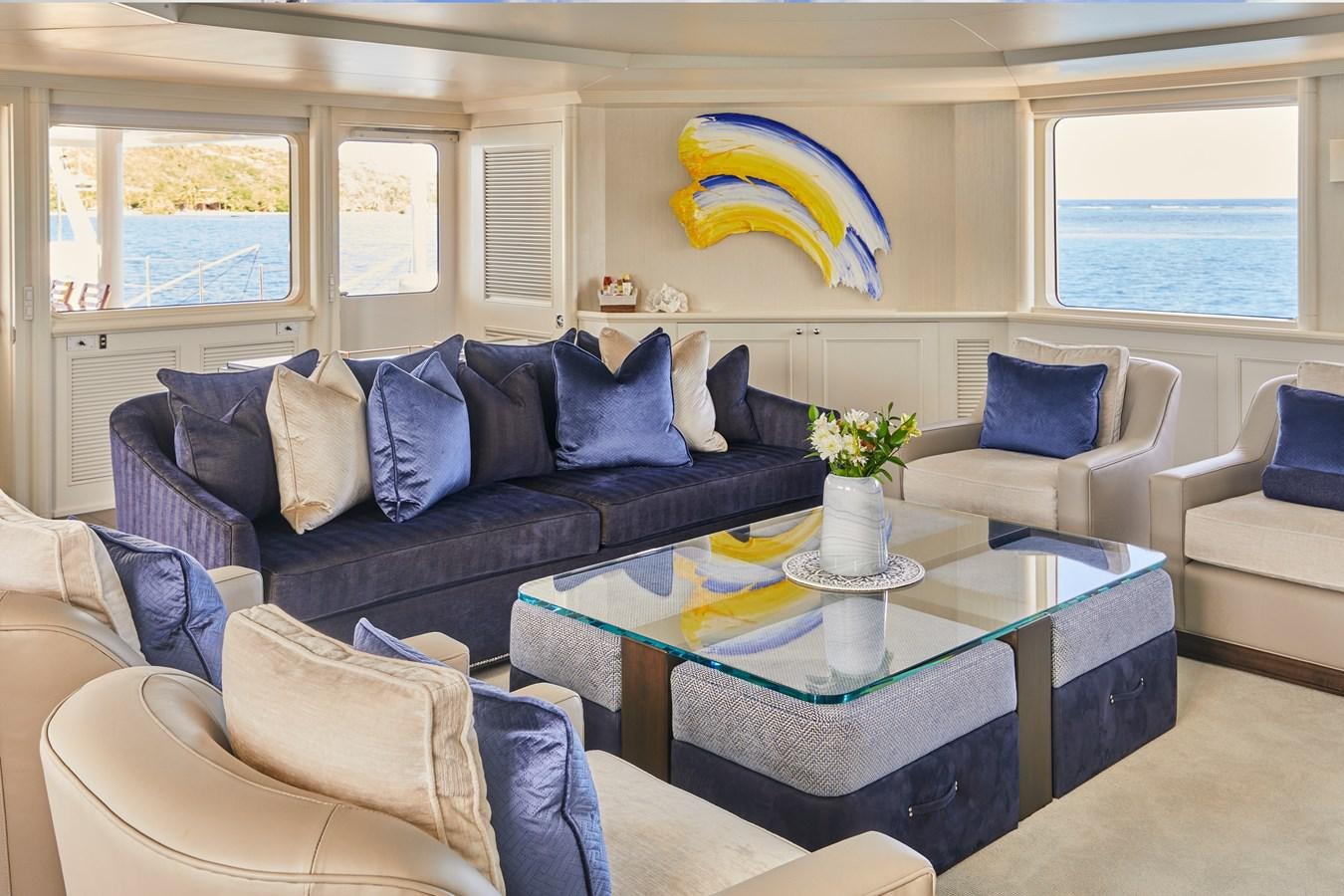 a living room with a couch and a coffee table aboard AMARA Yacht for Sale
