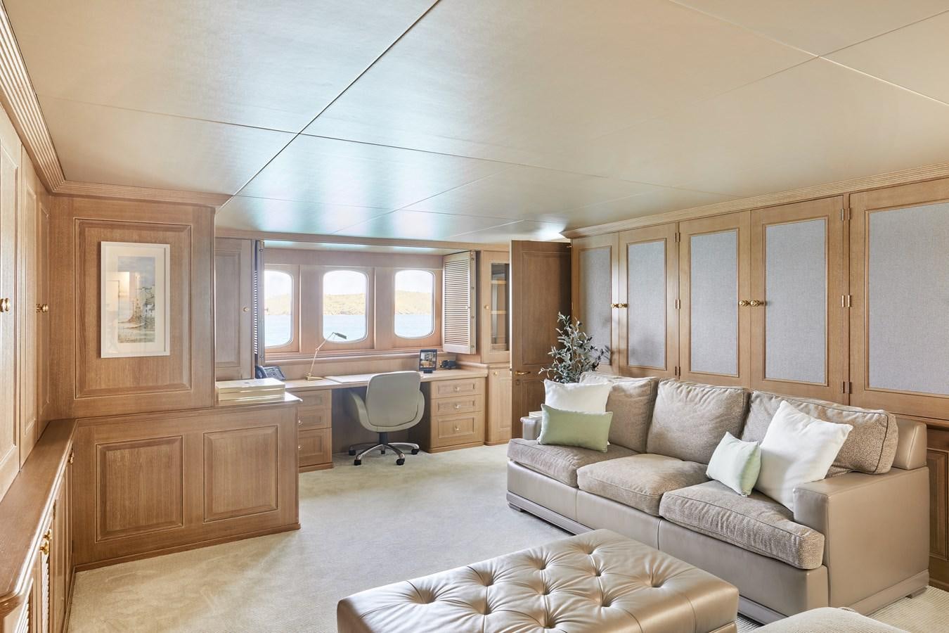 a living room with a couch and a chair aboard AMARA Yacht for Sale