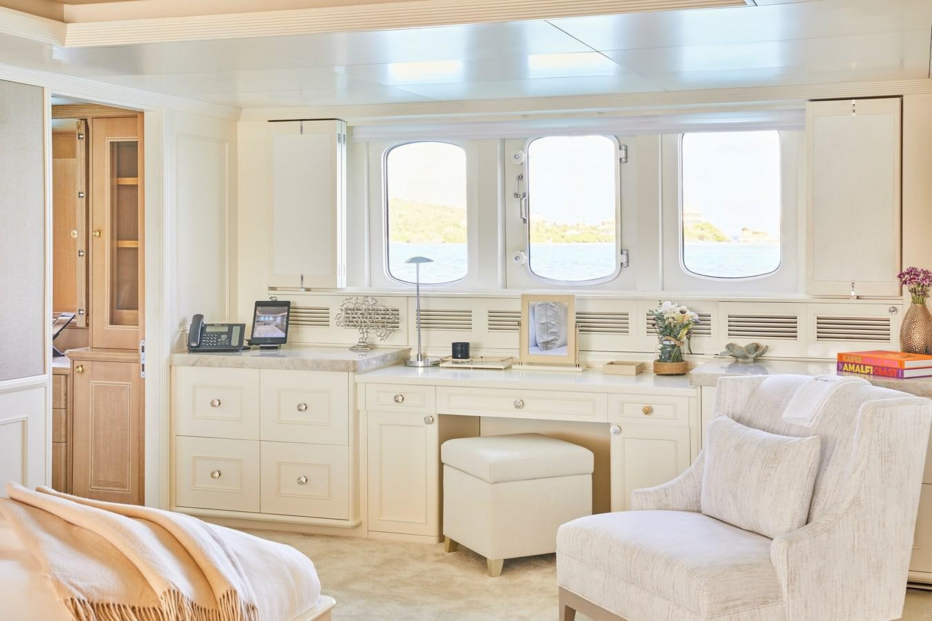 a kitchen with white cabinets aboard AMARA Yacht for Sale