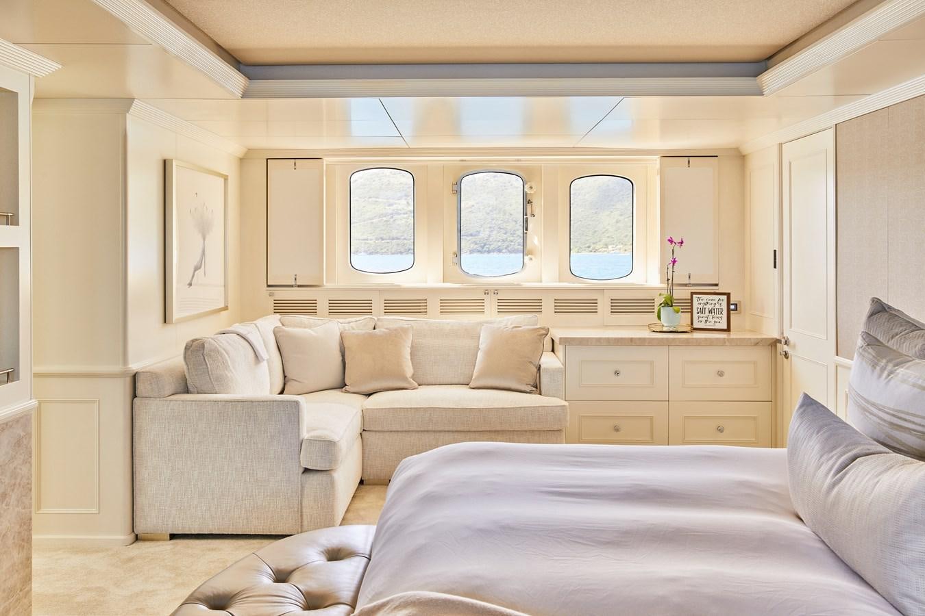 a living room with a bed and a couch aboard AMARA Yacht for Sale