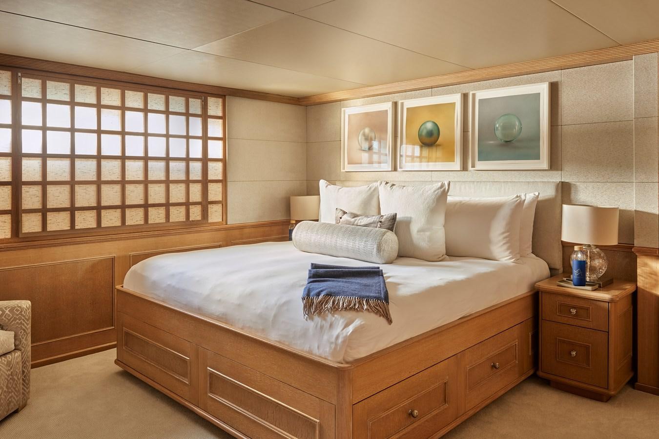 a bed with white sheets aboard AMARA Yacht for Sale