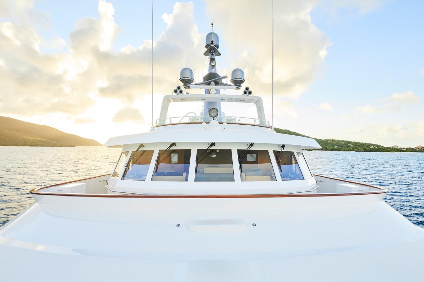 a white boat on the water aboard AMARA Yacht for Sale