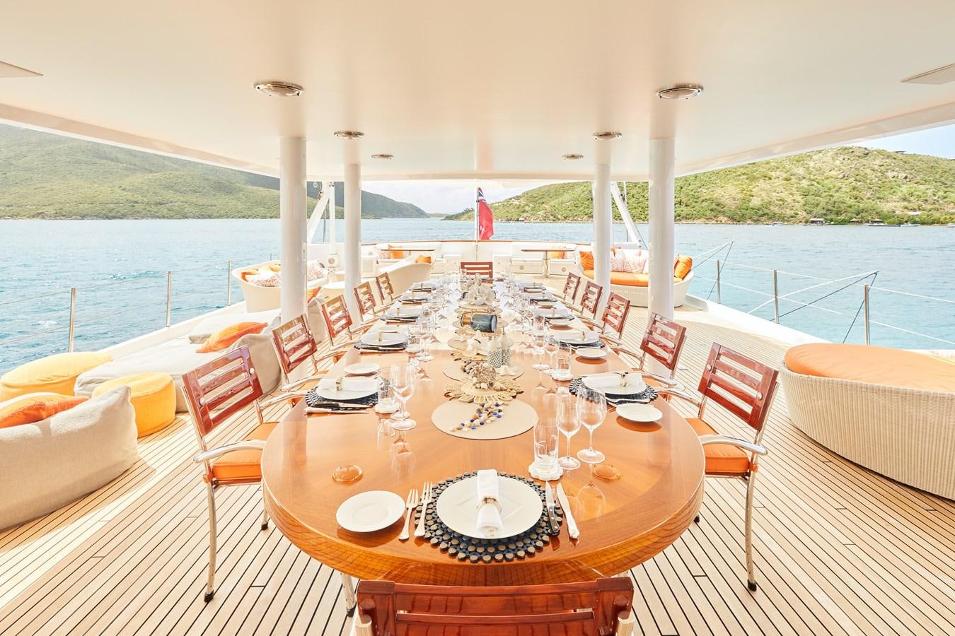 a table set for a dinner party aboard AMARA Yacht for Sale