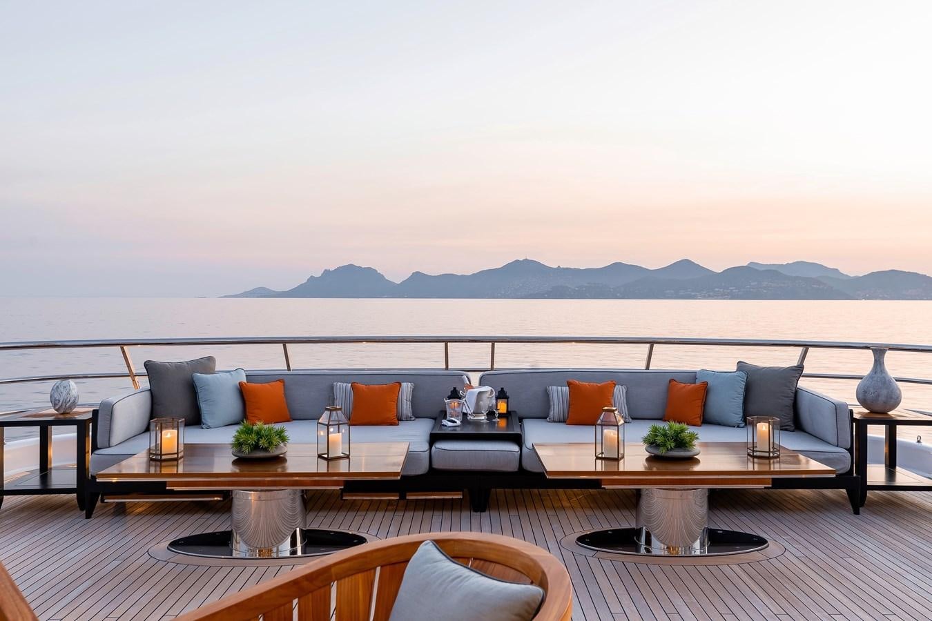 a living room with a large sofa aboard LIND Yacht for Sale