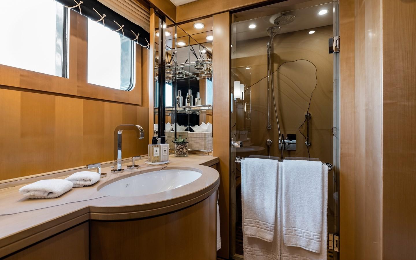 a bathroom with a glass shower aboard LIND Yacht for Sale