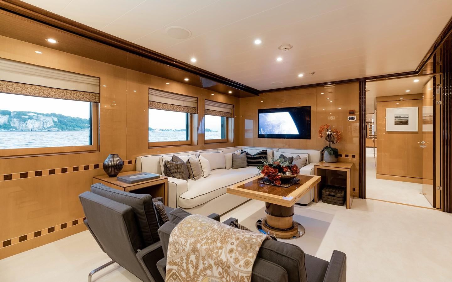a living room with a large screen aboard LIND Yacht for Sale