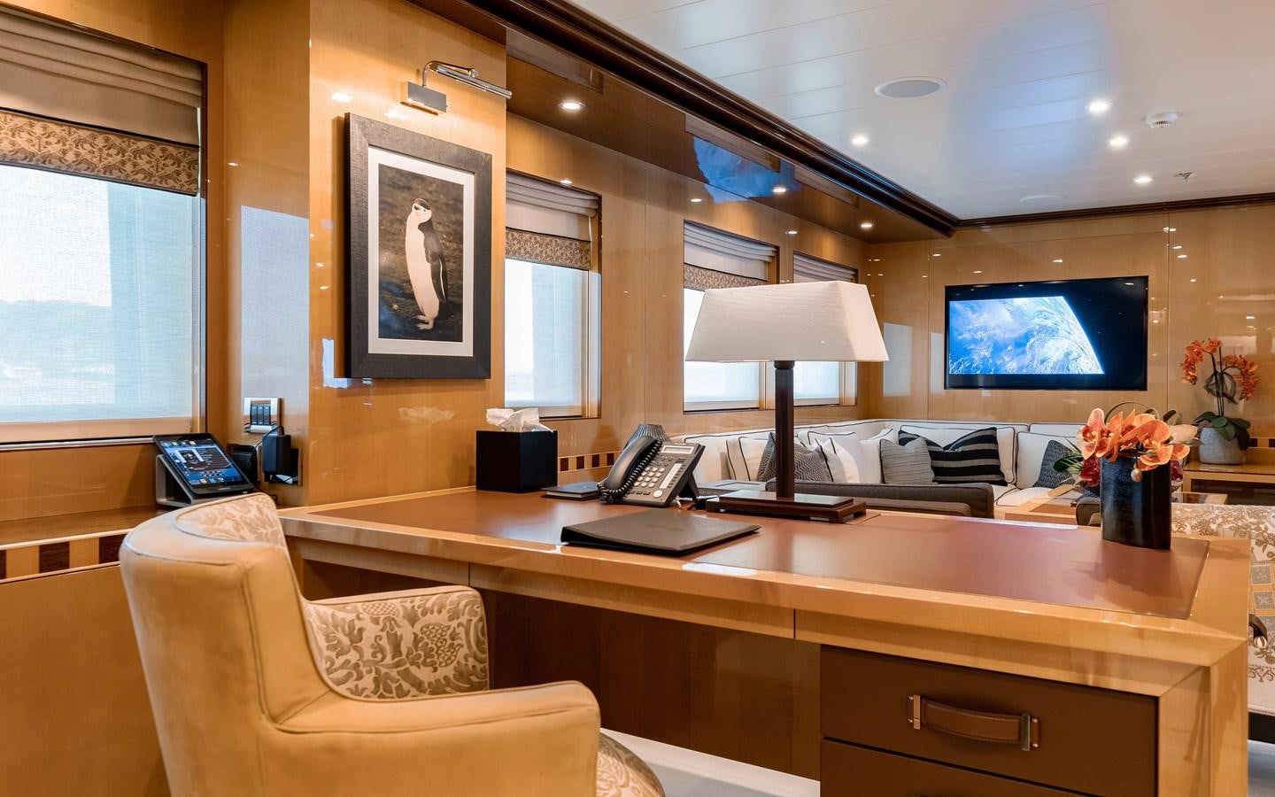 a room with a desk and a tv on the wall aboard LIND Yacht for Sale