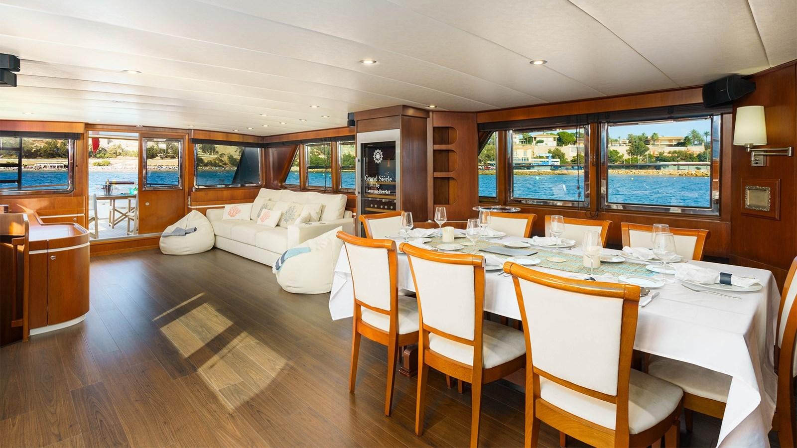 a large dining table in a living room aboard SPIRIT OF MK Yacht for Charter