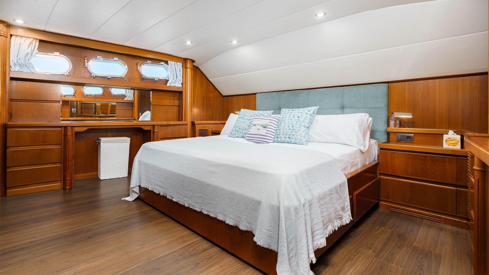 a room with a bed and a desk aboard SPIRIT OF MK Yacht for Charter