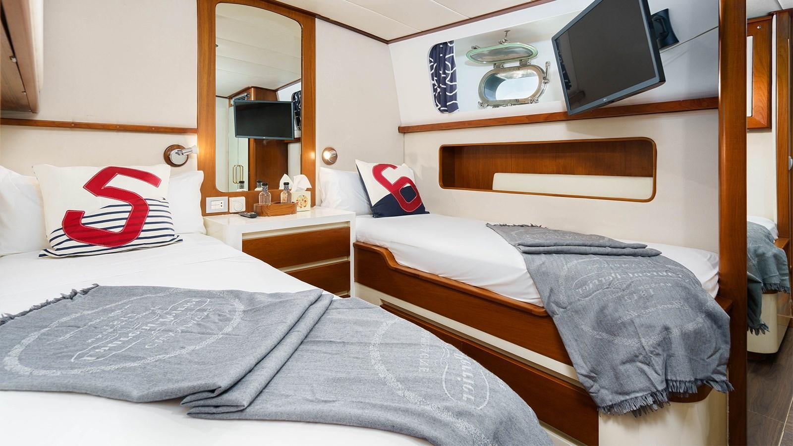 a couple of beds in a hotel room aboard SPIRIT OF MK Yacht for Charter