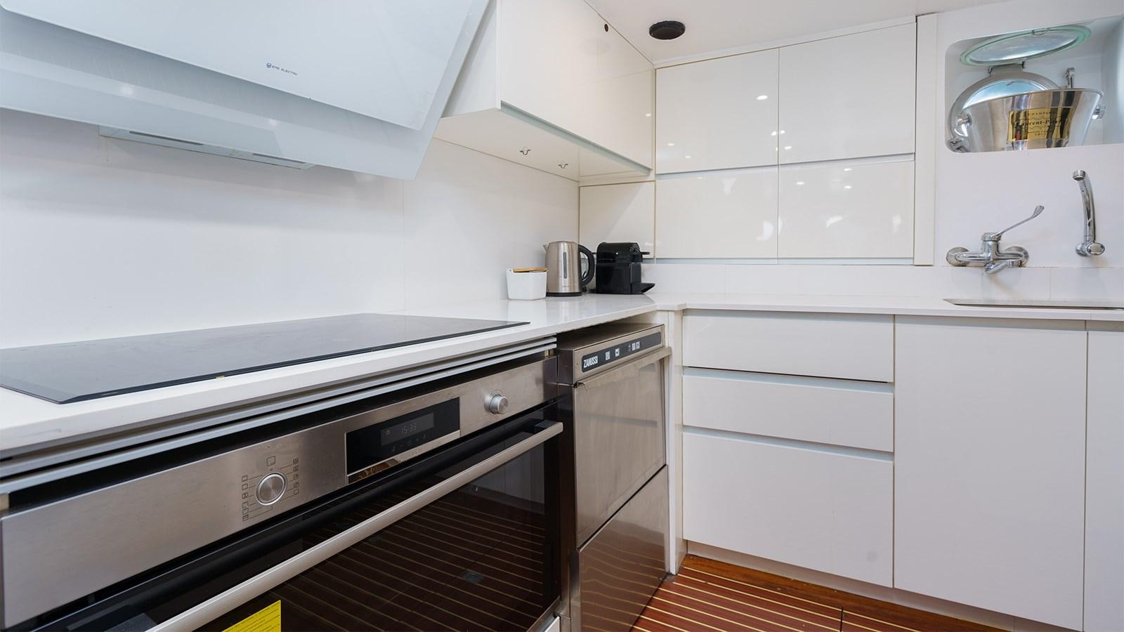 a kitchen with white cabinets aboard SPIRIT OF MK Yacht for Sale