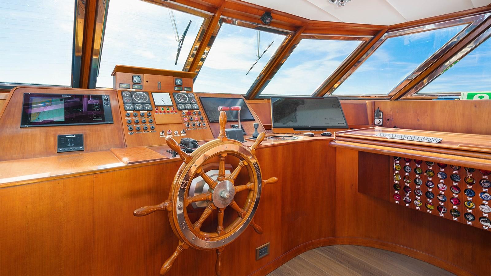 a wooden boat with a steering wheel aboard SPIRIT OF MK Yacht for Sale